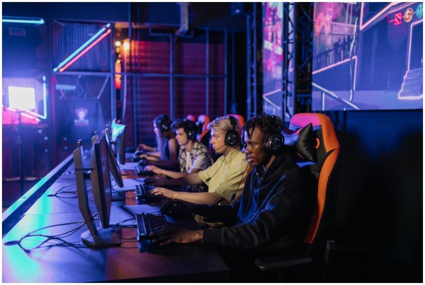 A group of focused teenagers playing in an esports
