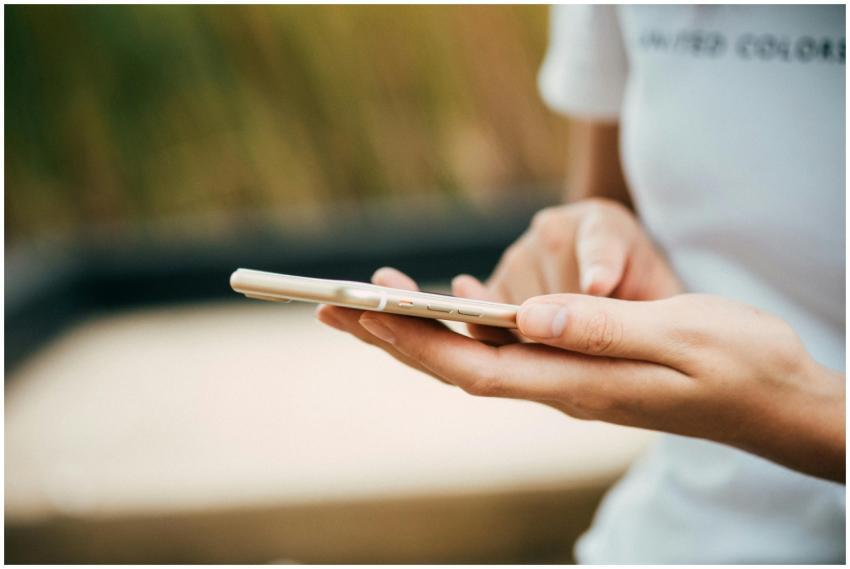 Close-up of a person using a smartphone outdoors,