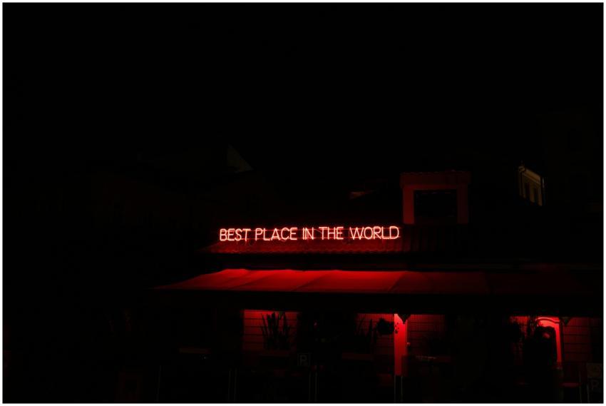 A captivating red neon sign illuminating a buildin