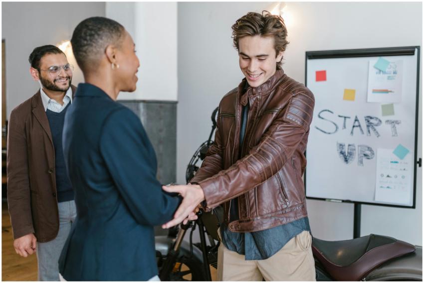 Professional young entrepreneurs shaking hands dur