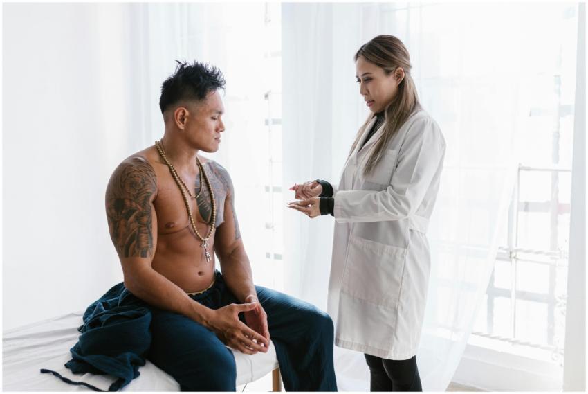 A doctor consults with a shirtless man in a clinic