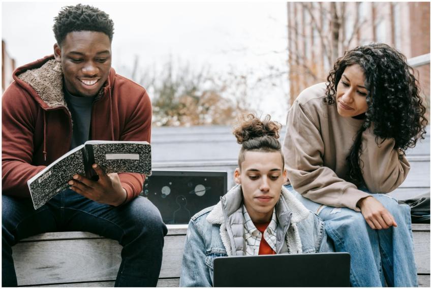 Group of multiethnic happy young students doing ho