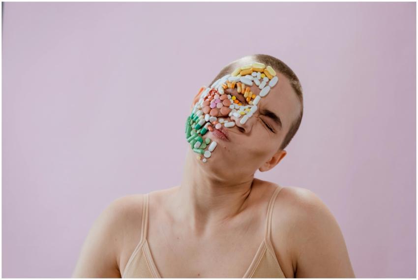 Conceptual portrait of a woman with pills on her f