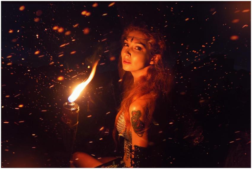 Captivating portrait of a woman holding a torch un