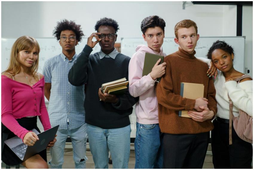 A group of diverse college students posing with bo