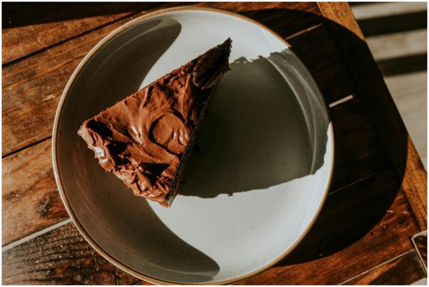 Appetizing slice of chocolate cake on a rustic woo
