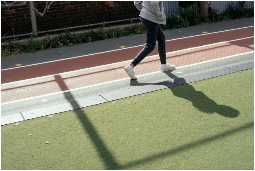 Crop faceless kid in sportswear holding hands in p