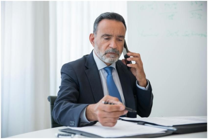 Senior businessman in a suit discussing business o