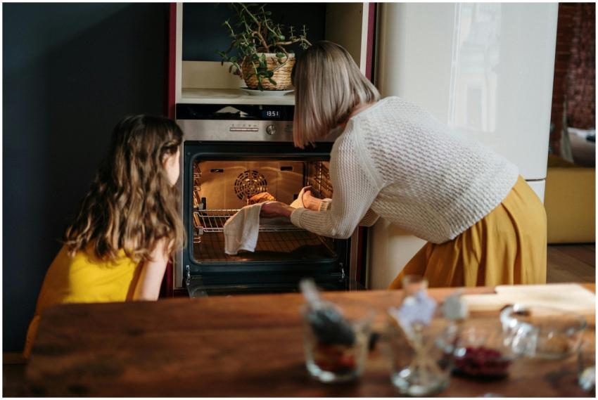 A mother and daughter baking a cake in a cozy kitc