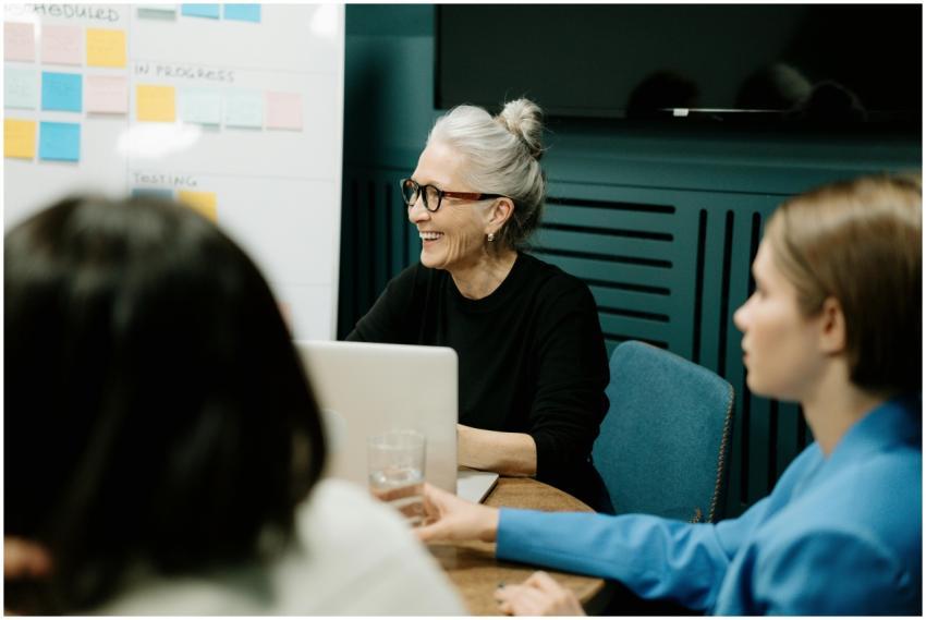 Smiling senior businesswoman leading a diverse tea