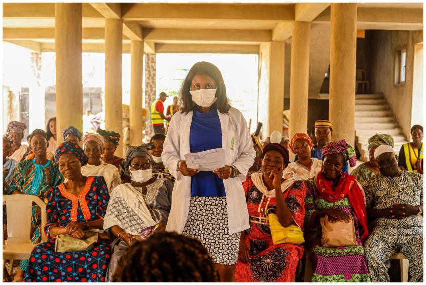 A female doctor giving a health lecture to a group