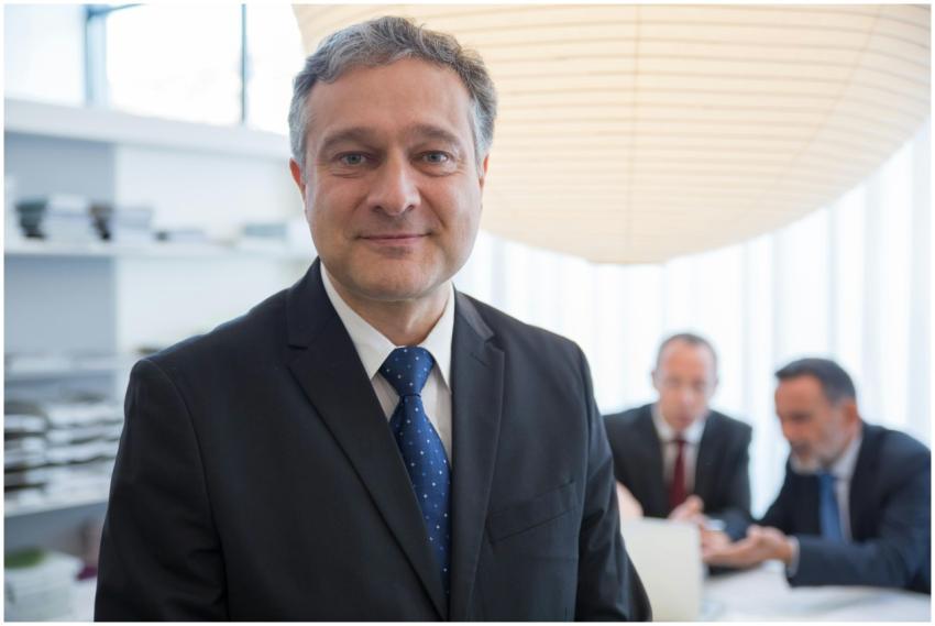 Businessman in a suit with colleagues in a modern