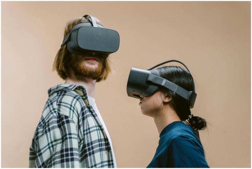 A man and woman wearing VR headsets, exploring vir