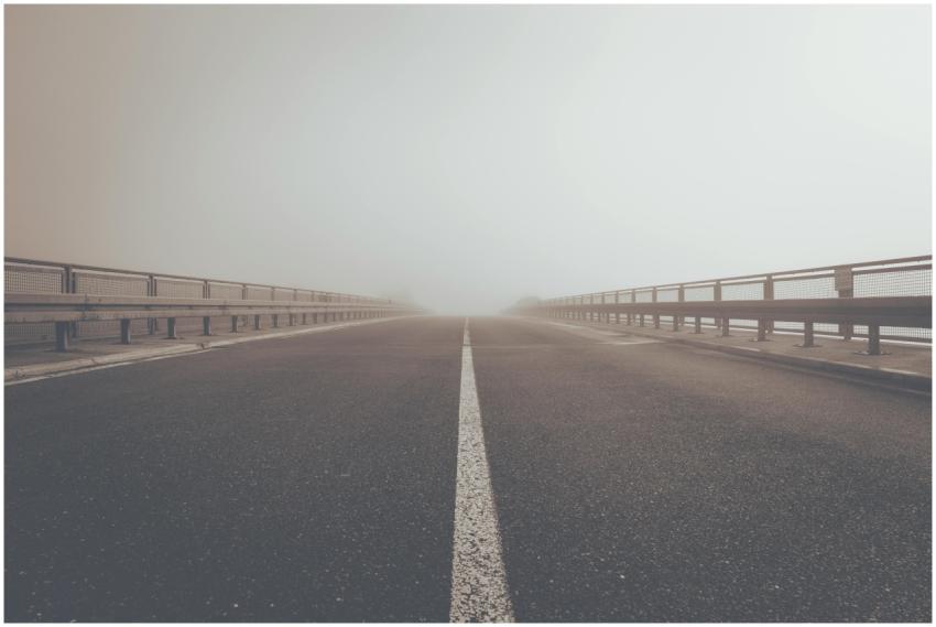 A misty road creating an atmospheric perspective a