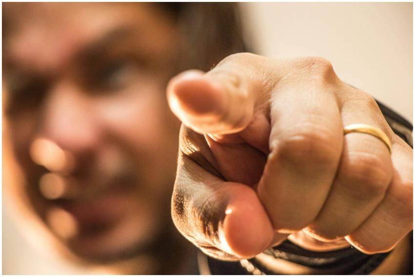 Dynamic close-up of a hand pointing forward with a