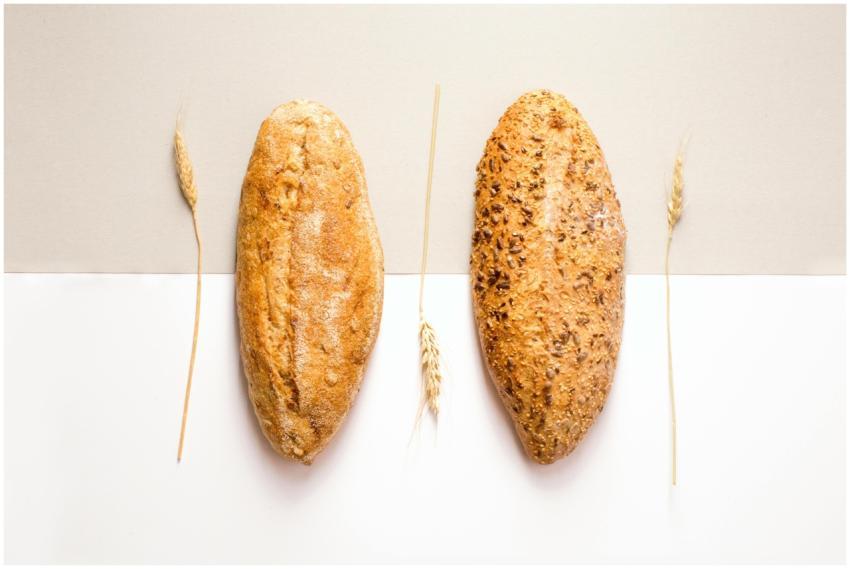 Flat lay image of two artisan bread loaves with wh