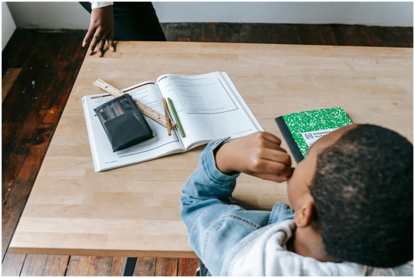 Child focuses on schoolwork at a desk, showcasing