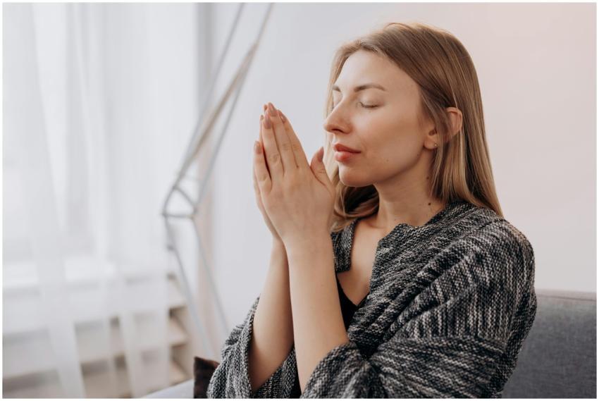 A serene woman practicing meditation indoors for r