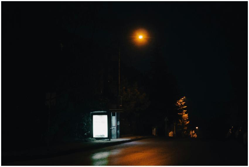 A quiet city street at night with an illuminated b