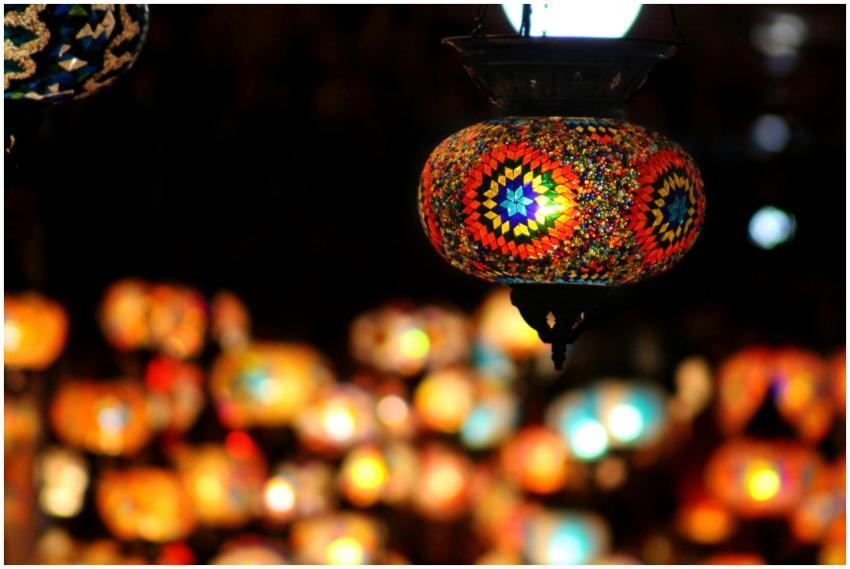 Vibrant mosaic lanterns glowing at a night market,