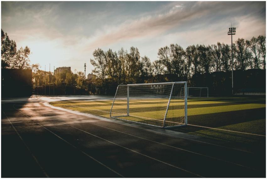 Beautiful view of an empty soccer field at sunset,