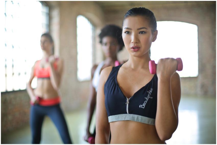 Women engaging in an indoor group fitness class wi