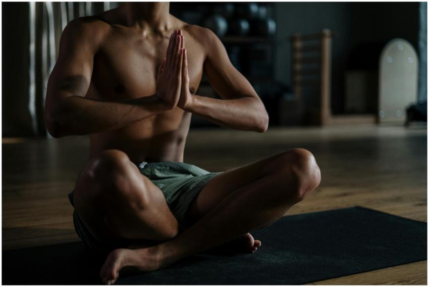 A young man meditates in a yoga studio, promoting