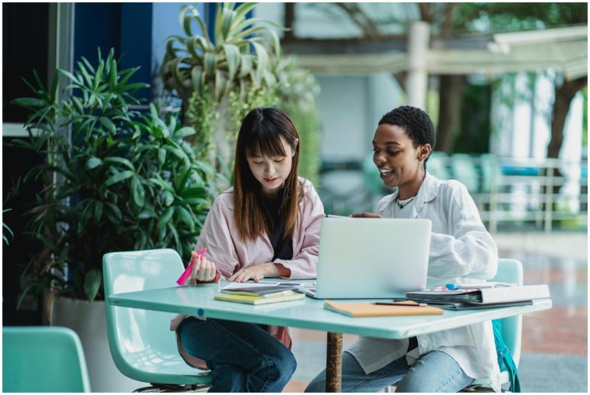 Young content diverse girlfriends talking while st