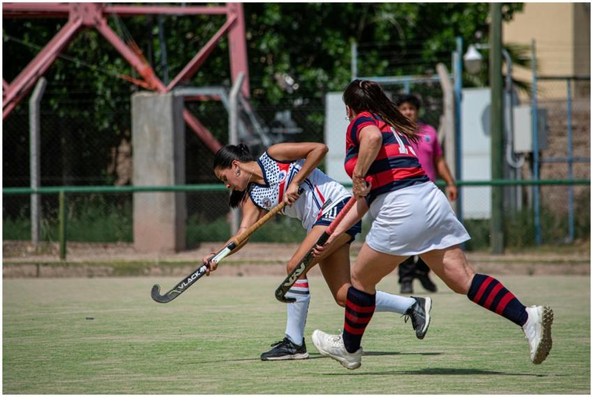 Intense game of women's field hockey showcasing de