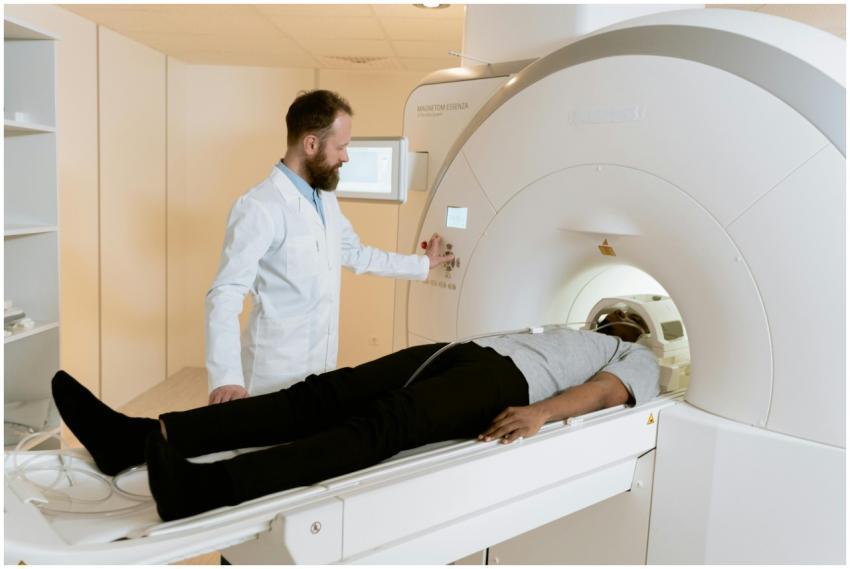 A doctor operates an MRI machine with a patient un