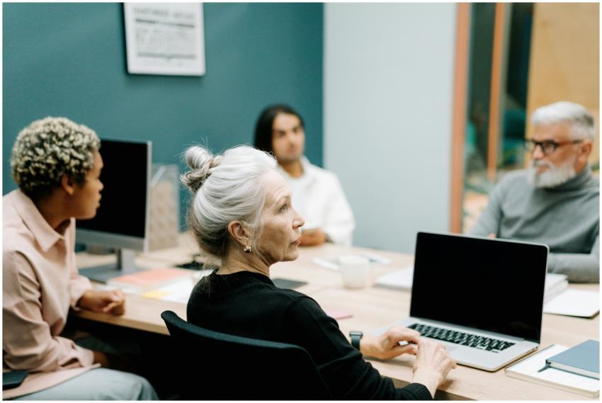 A multicultural team engaged in a meeting around a