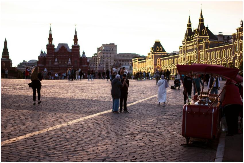A bustling city square at dusk, illuminated buildi