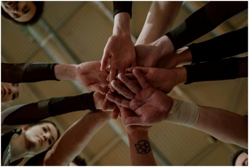 Group of people in a huddle showing unity and team