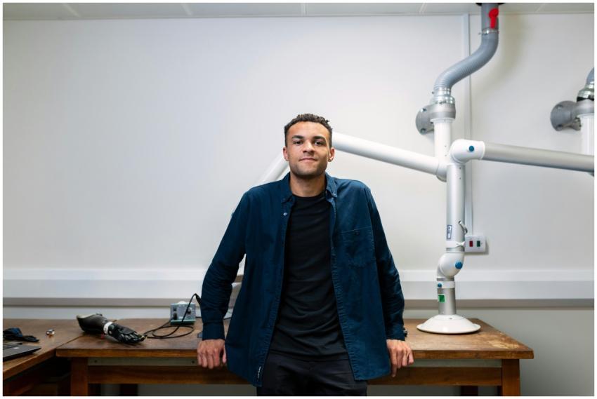 Confident young engineer standing in a laboratory