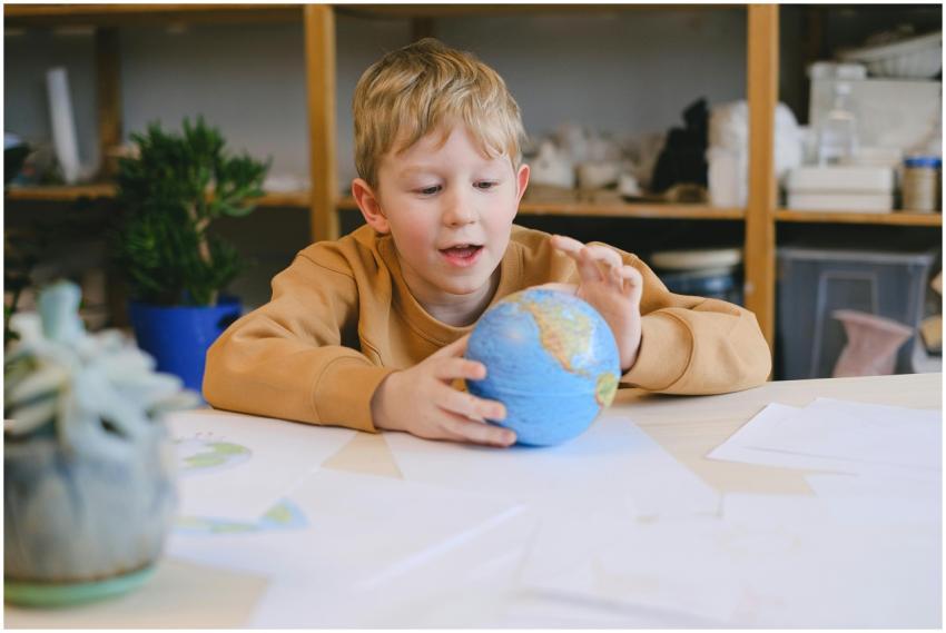 Young caucasian boy sitting indoors holding a smal