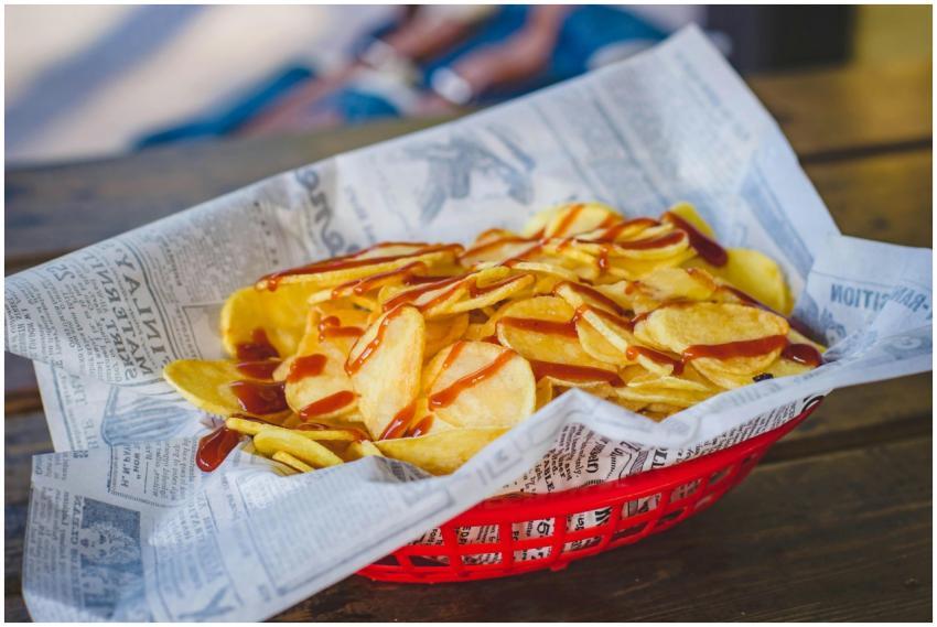 Close-up of crispy potato chips drizzled with ketc