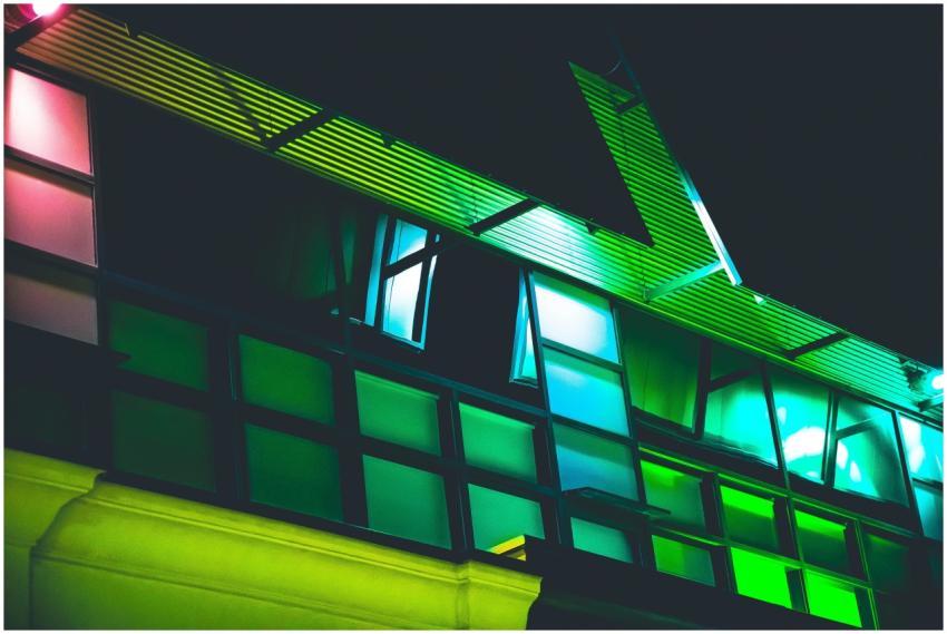 Vibrant green and blue illuminated building facade