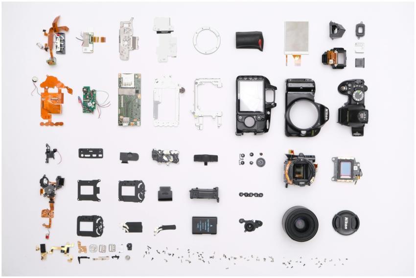 A detailed flat lay of disassembled camera compone