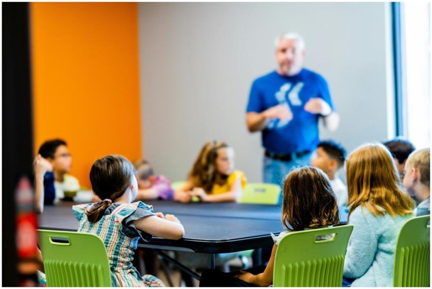 Children attentively listen to a teacher during a