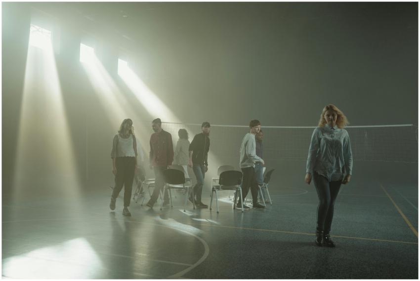 Group of people walking inside a smoky room with d