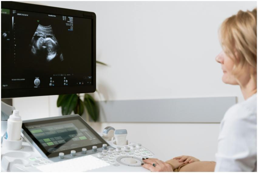A woman undergoing an ultrasound scan by a healthc