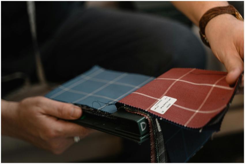 Close-up of hands holding fabric swatches with pla