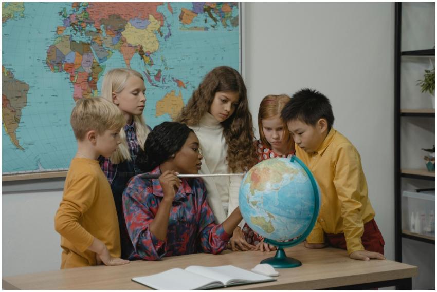 A diverse group of children learning geography wit