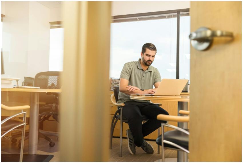 Professional man sitting at desk in modern office,