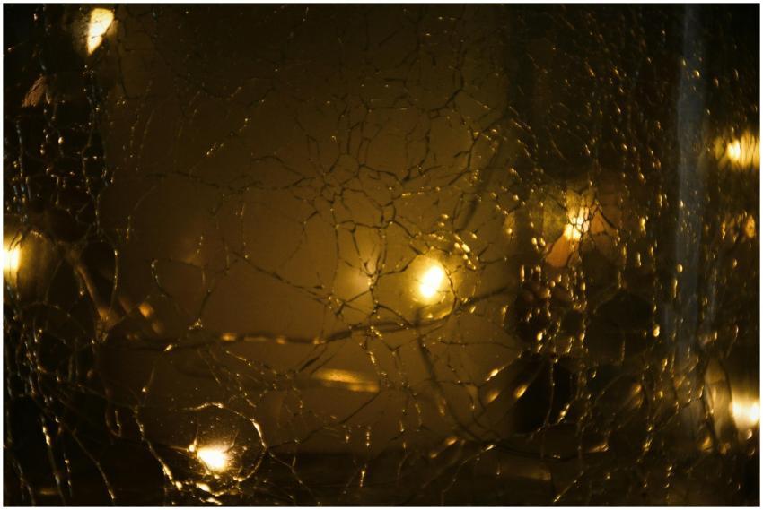 Cracked glass with a warm glow and bokeh effect, c