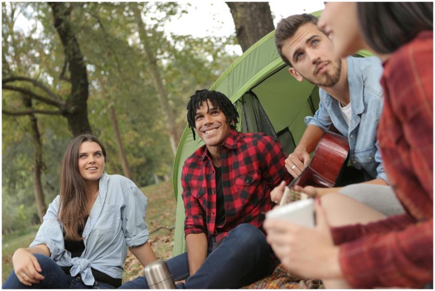Group of young friends in casual clothes sitting o