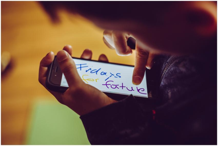 A close-up of a child using a smartphone, highligh