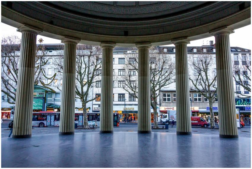 Neoclassical columns framing a street view in Aach
