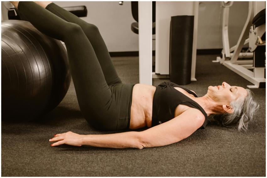 Senior woman using fitness ball for core exercise
