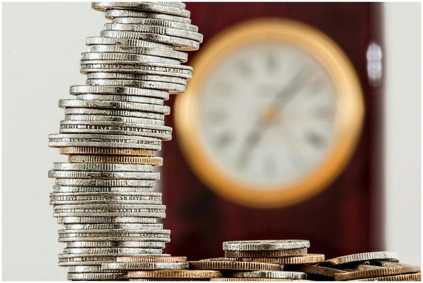 A close-up image of stacked coins with a blurred c